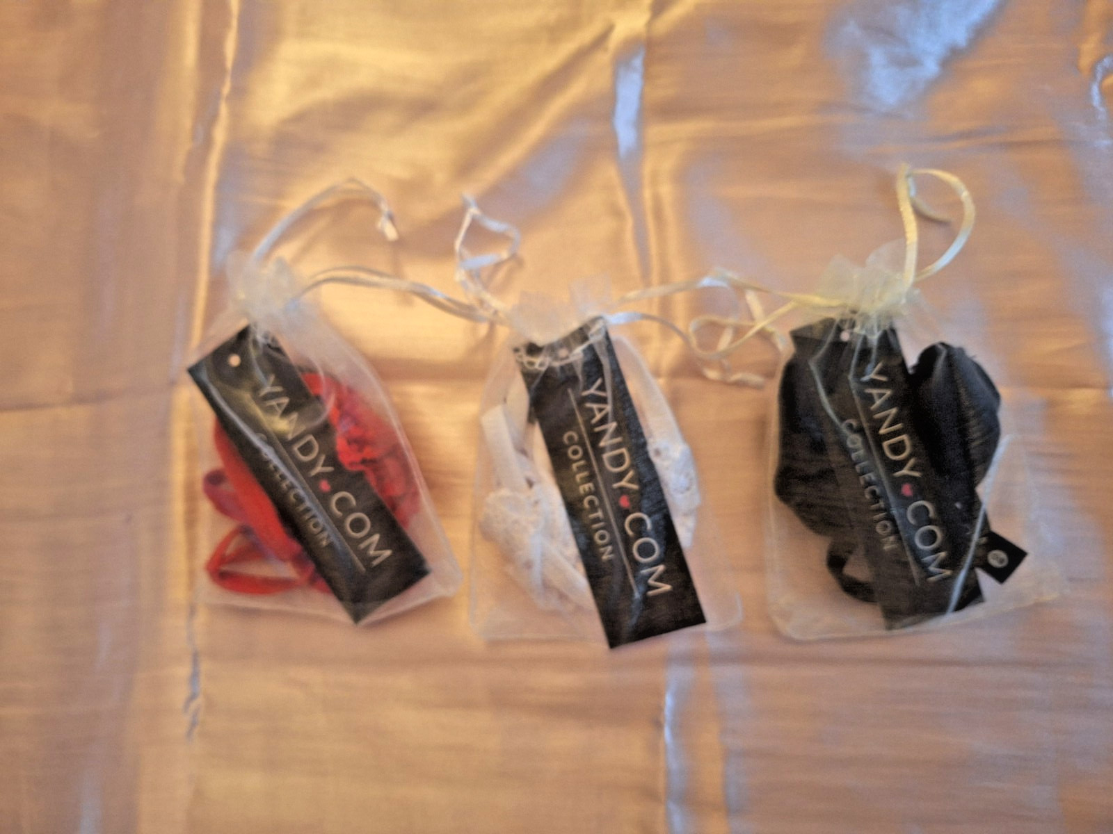 Yandy crotchless lace thongs in red, black, white (One size) Lot of (3)
