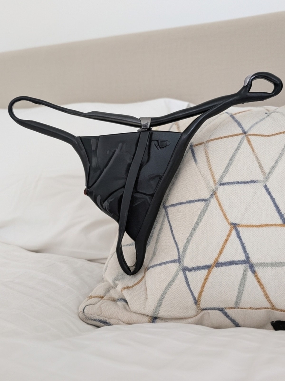 black satin thong with thin straps and minimal coverage