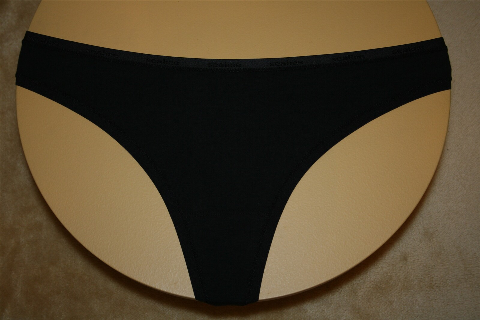 This is a Cute Black Thong with Shiny “SeaLine” Written on the Band – L